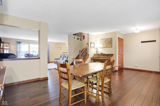 dining area featuring dark wood-type flooring