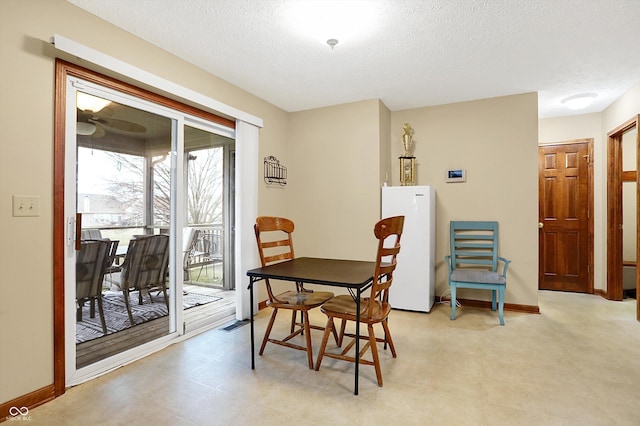 dining space with a textured ceiling