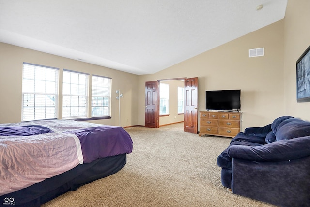 carpeted bedroom with lofted ceiling