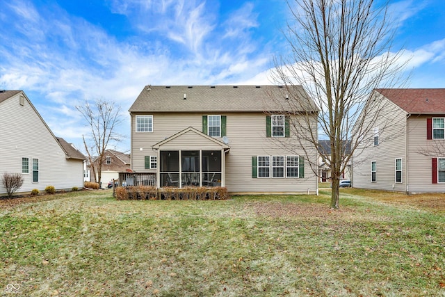 rear view of house with a yard and a sunroom