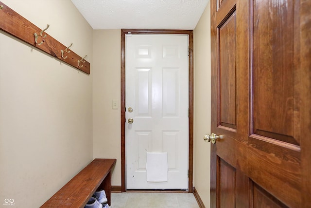 doorway with a textured ceiling