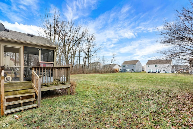 view of yard featuring a sunroom and a deck