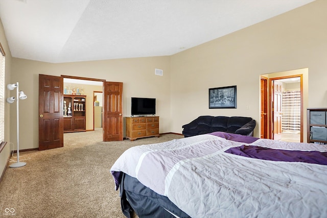 carpeted bedroom with vaulted ceiling