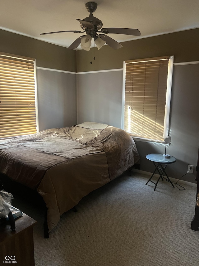 bedroom featuring ceiling fan and carpet