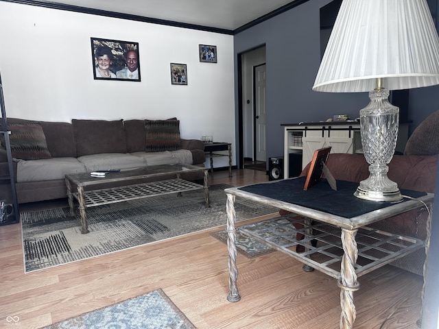 living area with ornamental molding and wood finished floors