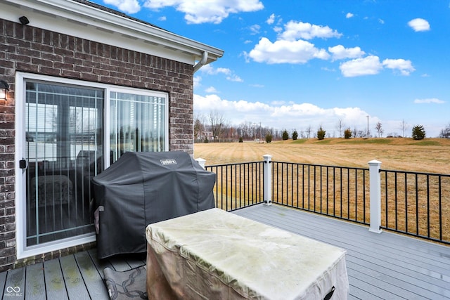 wooden deck with grilling area and a jacuzzi