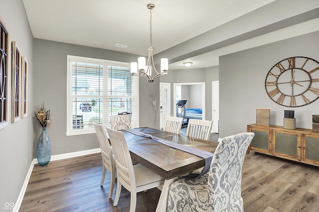 dining room featuring an inviting chandelier and hardwood / wood-style flooring