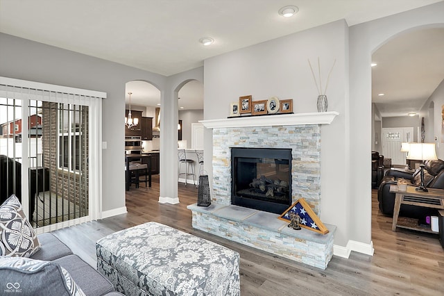 living room with hardwood / wood-style flooring and a fireplace