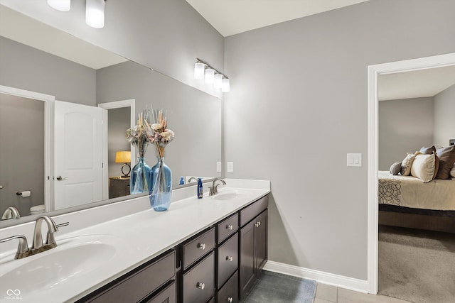 bathroom with tile patterned flooring, vanity, and toilet