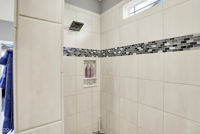 bathroom with a tile shower