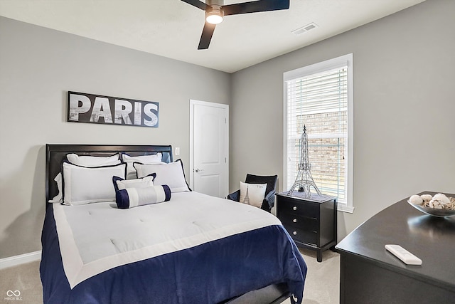 bedroom featuring light carpet and ceiling fan