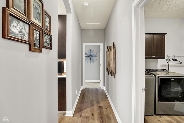 hall featuring separate washer and dryer and light hardwood / wood-style flooring