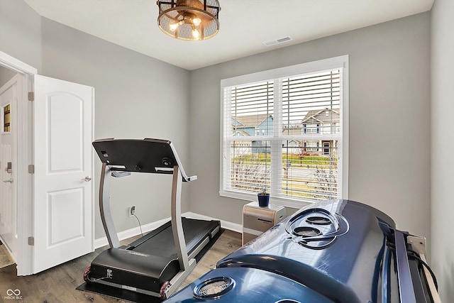 exercise area with dark hardwood / wood-style flooring