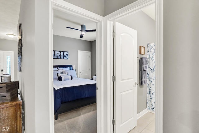 tiled bedroom featuring ceiling fan