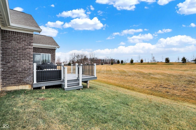 view of yard with a rural view and a deck