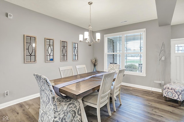 dining room featuring an inviting chandelier, hardwood / wood-style floors, and a wealth of natural light