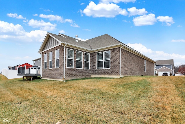 view of home's exterior with a wooden deck and a yard