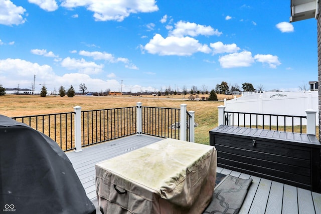 wooden deck with grilling area and a lawn