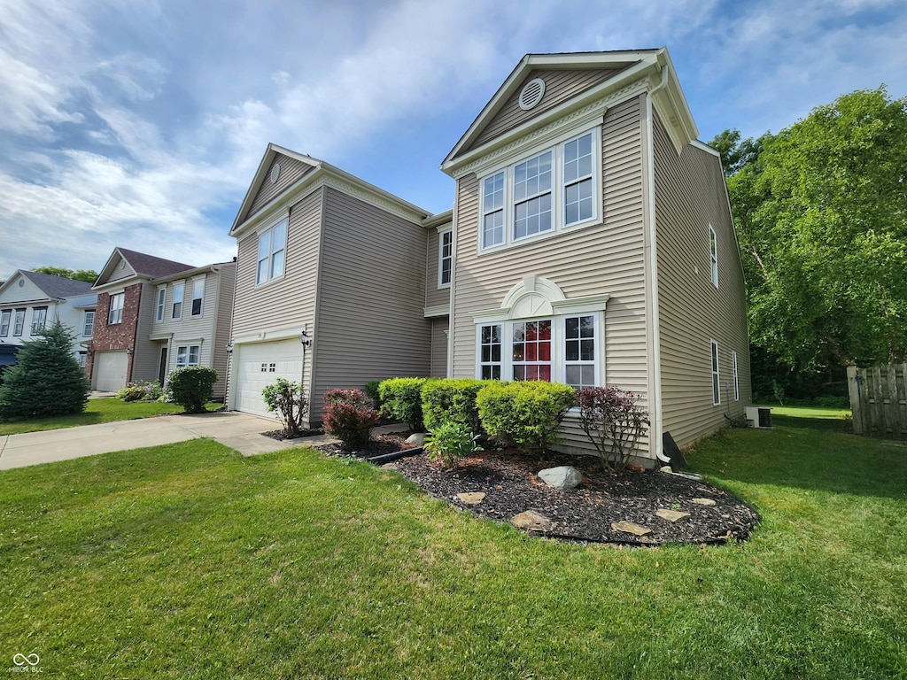 view of front of property featuring a garage and a front lawn