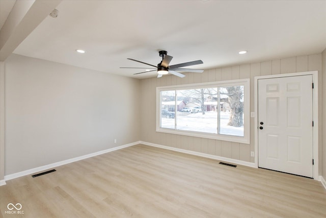 foyer with ceiling fan and light wood-type flooring