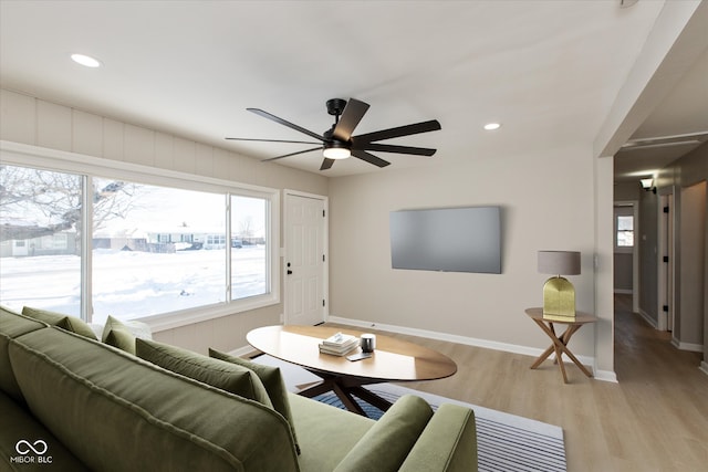 living room with ceiling fan and light hardwood / wood-style flooring