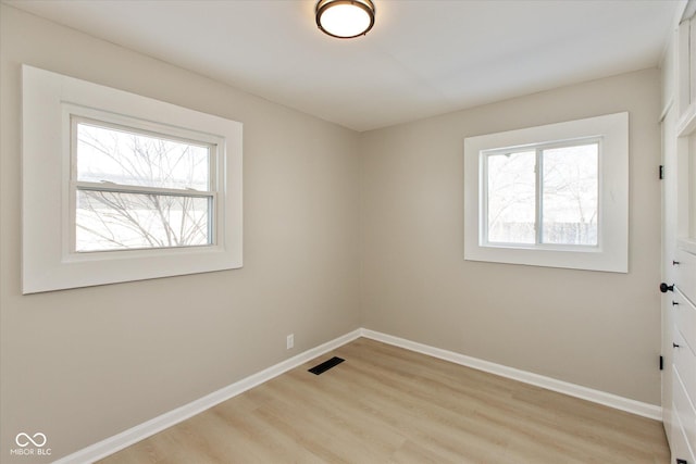 spare room featuring light hardwood / wood-style floors