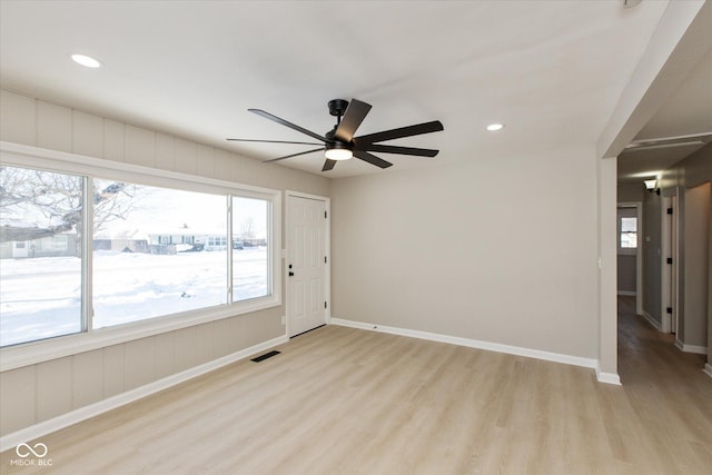 empty room with light hardwood / wood-style flooring and ceiling fan