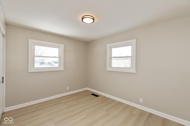 unfurnished room with light hardwood / wood-style flooring