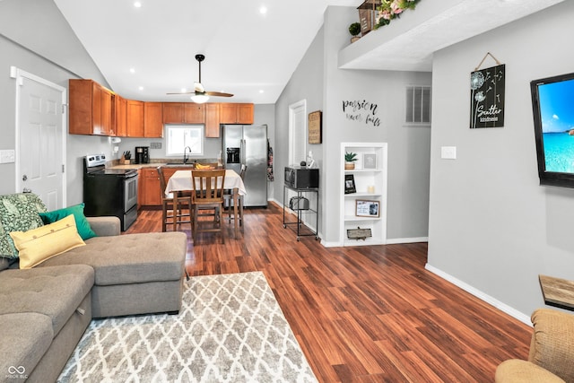 living room featuring lofted ceiling, sink, built in features, ceiling fan, and dark hardwood / wood-style flooring