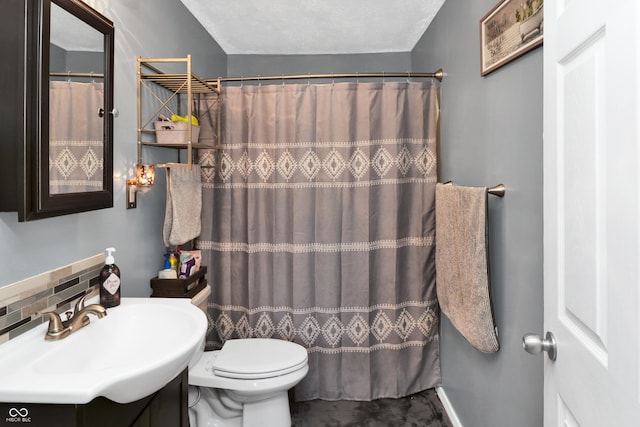 bathroom with vanity, toilet, and curtained shower