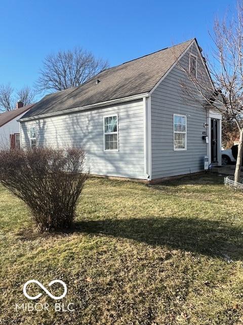 view of side of home featuring a lawn