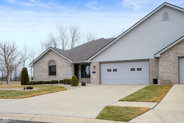 view of front of house with a garage and a front lawn