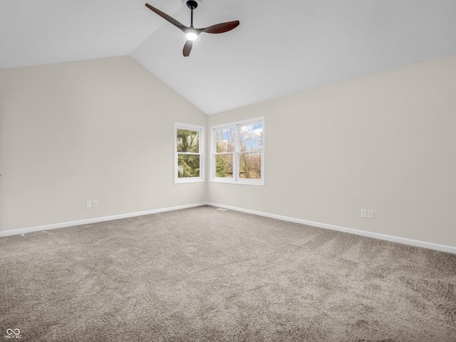 empty room featuring vaulted ceiling, carpet flooring, and ceiling fan