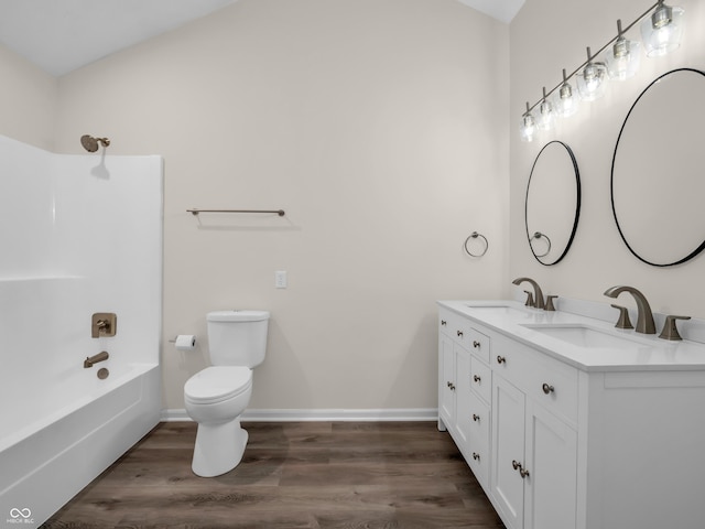 full bathroom with hardwood / wood-style flooring, vanity, toilet, and bathtub / shower combination