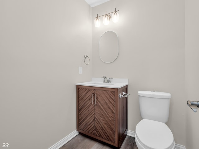 bathroom featuring vanity, hardwood / wood-style floors, and toilet