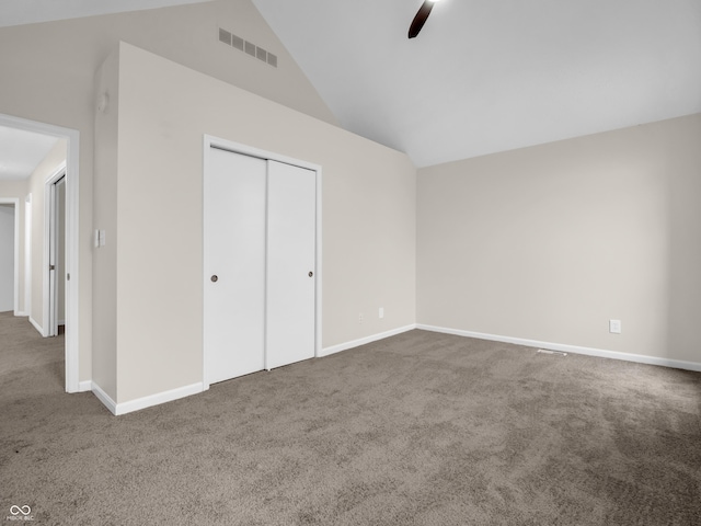 unfurnished bedroom with carpet, high vaulted ceiling, ceiling fan, and a closet