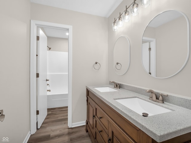 bathroom featuring vanity, hardwood / wood-style flooring, and shower / tub combination