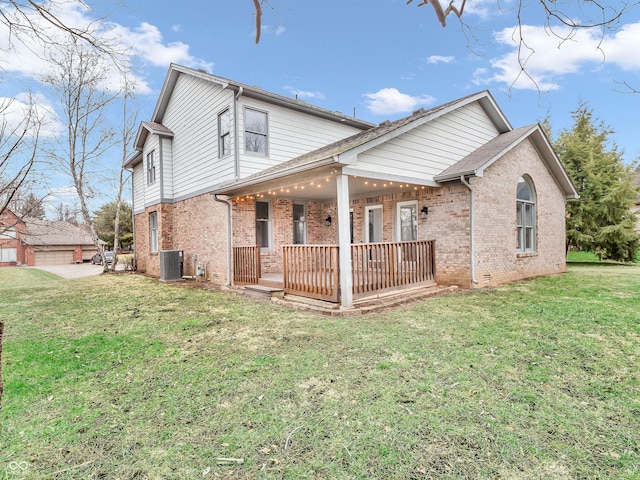 rear view of house featuring cooling unit, a lawn, and a porch