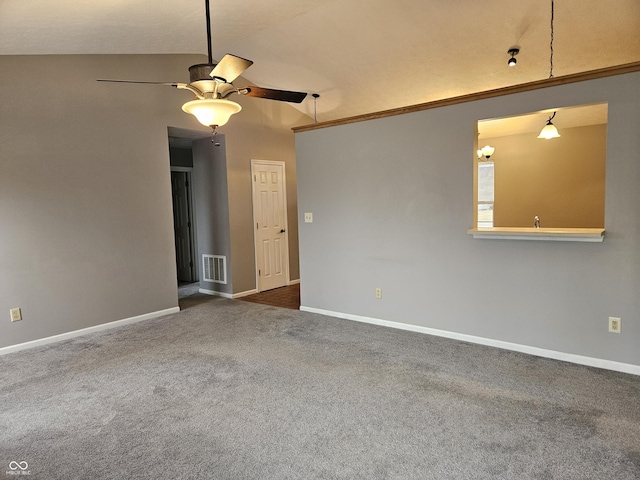 carpeted spare room featuring lofted ceiling and ceiling fan