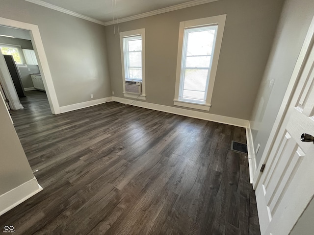 empty room with ornamental molding, dark hardwood / wood-style floors, and cooling unit