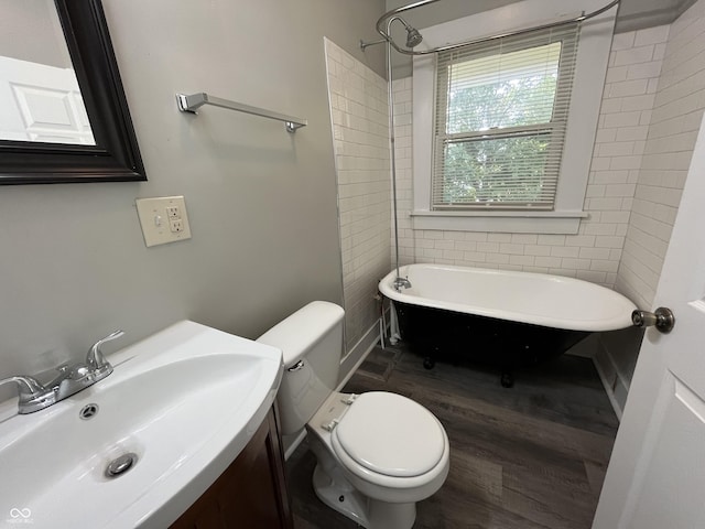 bathroom with toilet, sink, a bathtub, and hardwood / wood-style floors