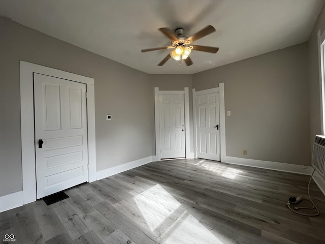 unfurnished bedroom with hardwood / wood-style flooring and ceiling fan