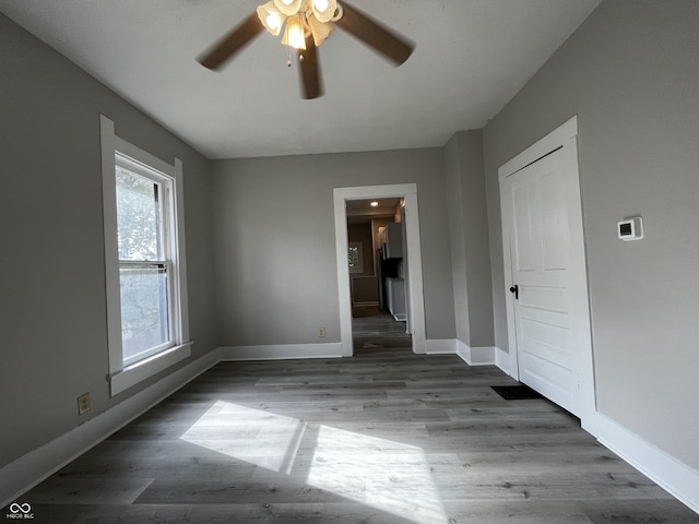 unfurnished room featuring ceiling fan and dark hardwood / wood-style flooring