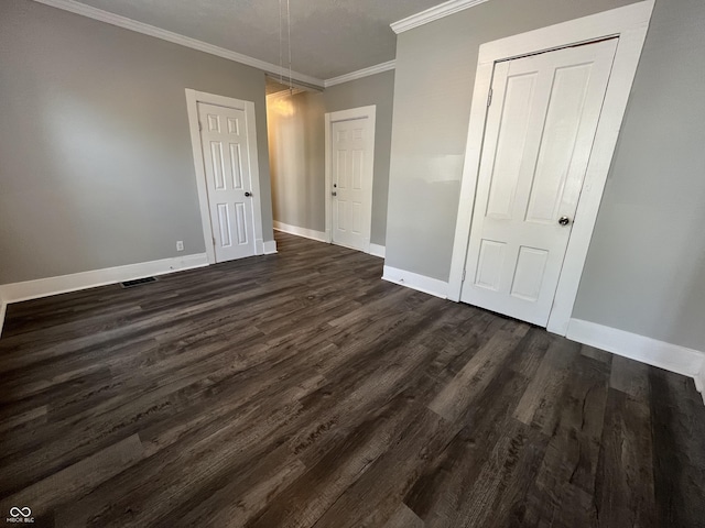 unfurnished bedroom featuring dark wood-type flooring and ornamental molding