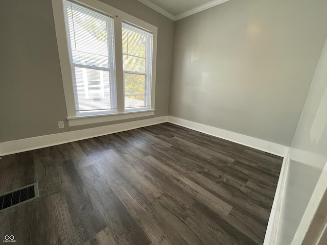 spare room with crown molding and dark hardwood / wood-style floors