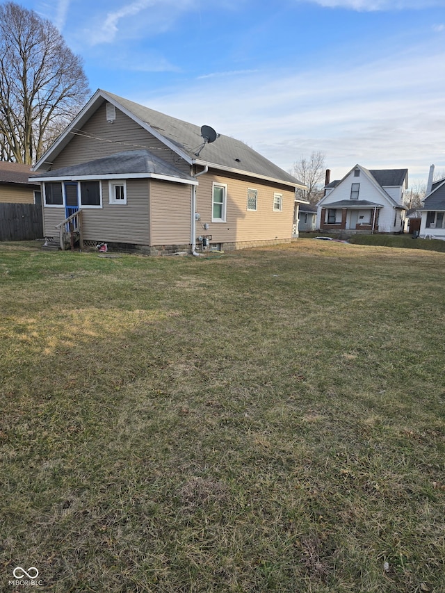 rear view of house with a yard