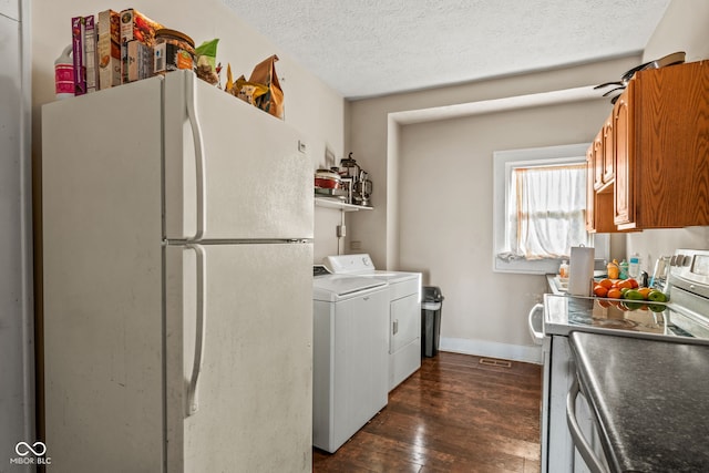 laundry area featuring washer and dryer, dark hardwood / wood-style floors, and a textured ceiling