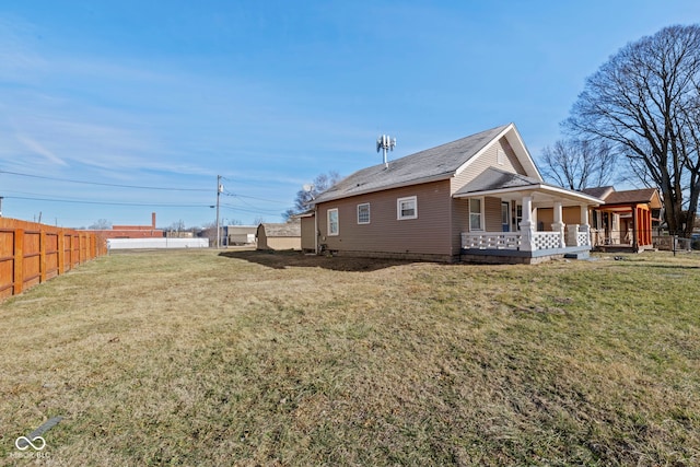 view of side of home featuring a lawn and a porch