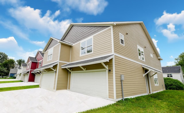 view of property exterior featuring a garage and a yard