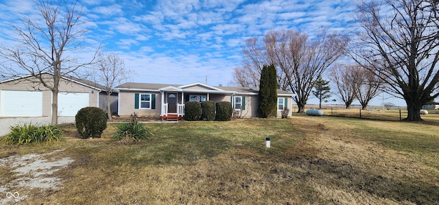 ranch-style home with a garage and a front lawn